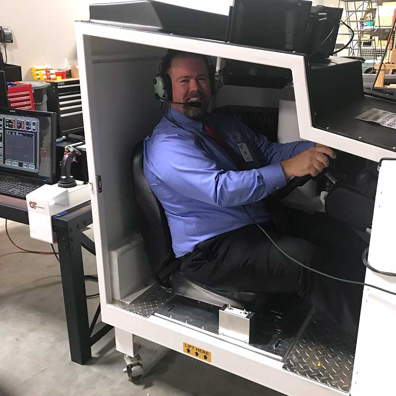 Volusia County Judge Chris Miller sitting in the OTTS Stryker training simulator